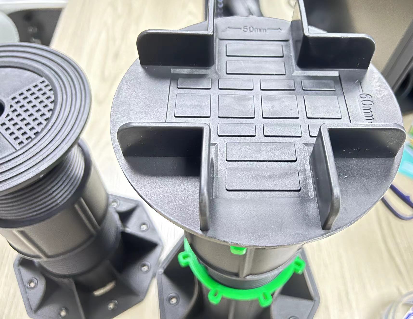 Adjustable plastic pedestal used in a raised deck system